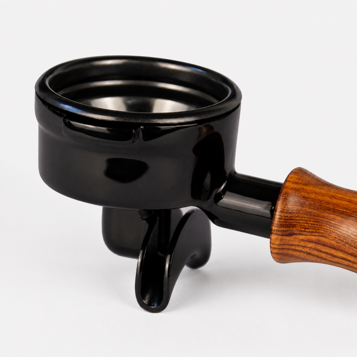A glossy black portafilter holder with a brown wood-grain handle, shown on a clean white background.
