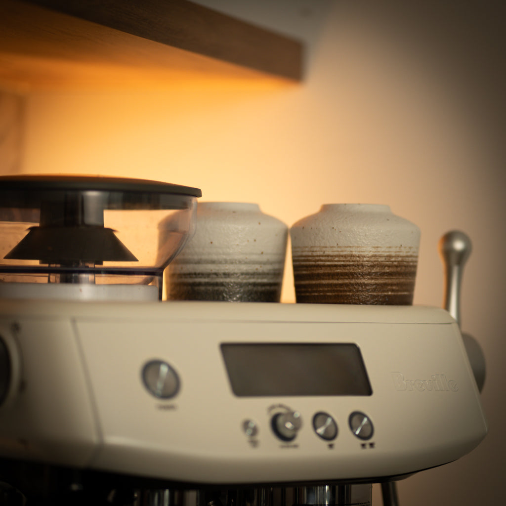 Ceramic Coffee Mugs Sitting on Coffee Machine
